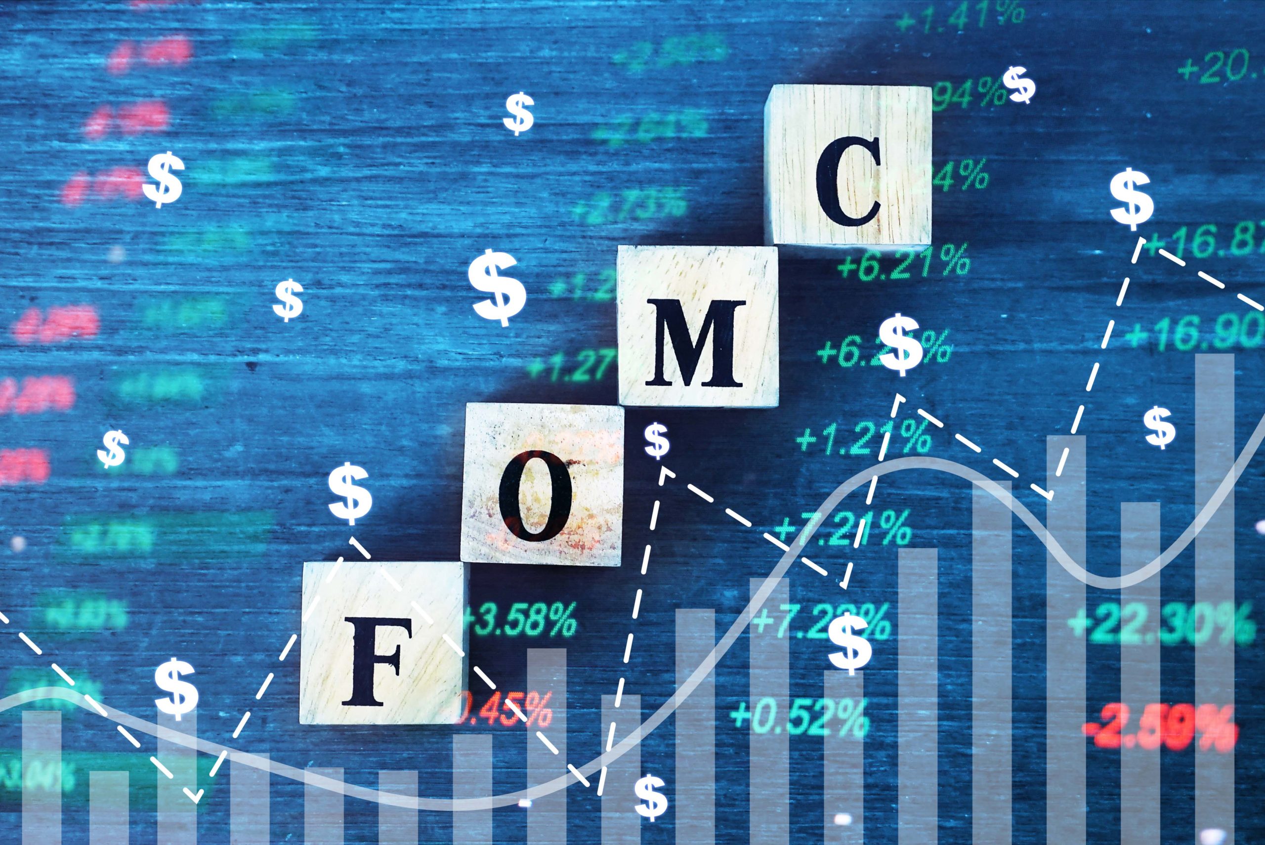 FOMC text with a financial chart background and US dollar symbols