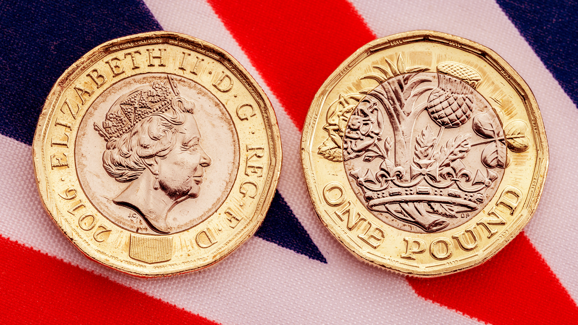 Pound coins placed on UK flag while pound is at all-time low