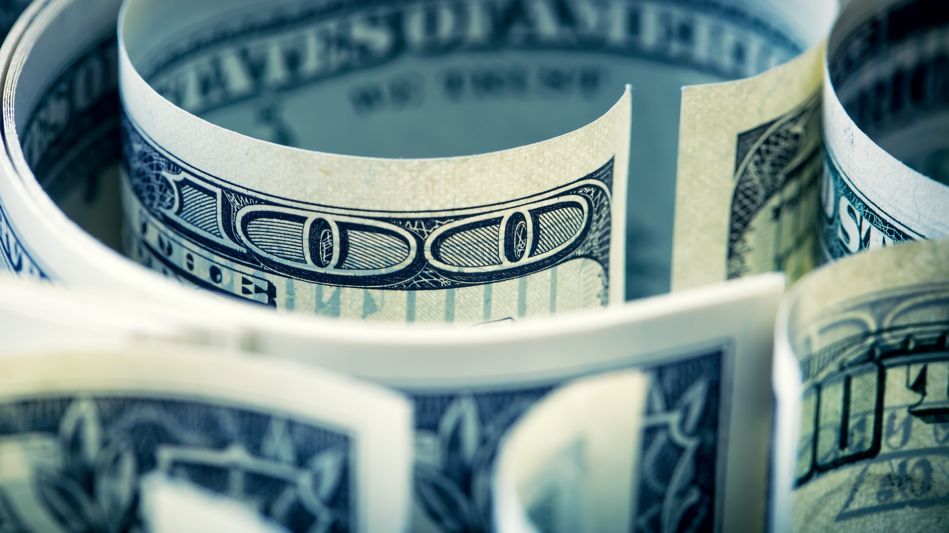 Rolls of US dollar bills amid The Dollar Index Returns to Levels of 104